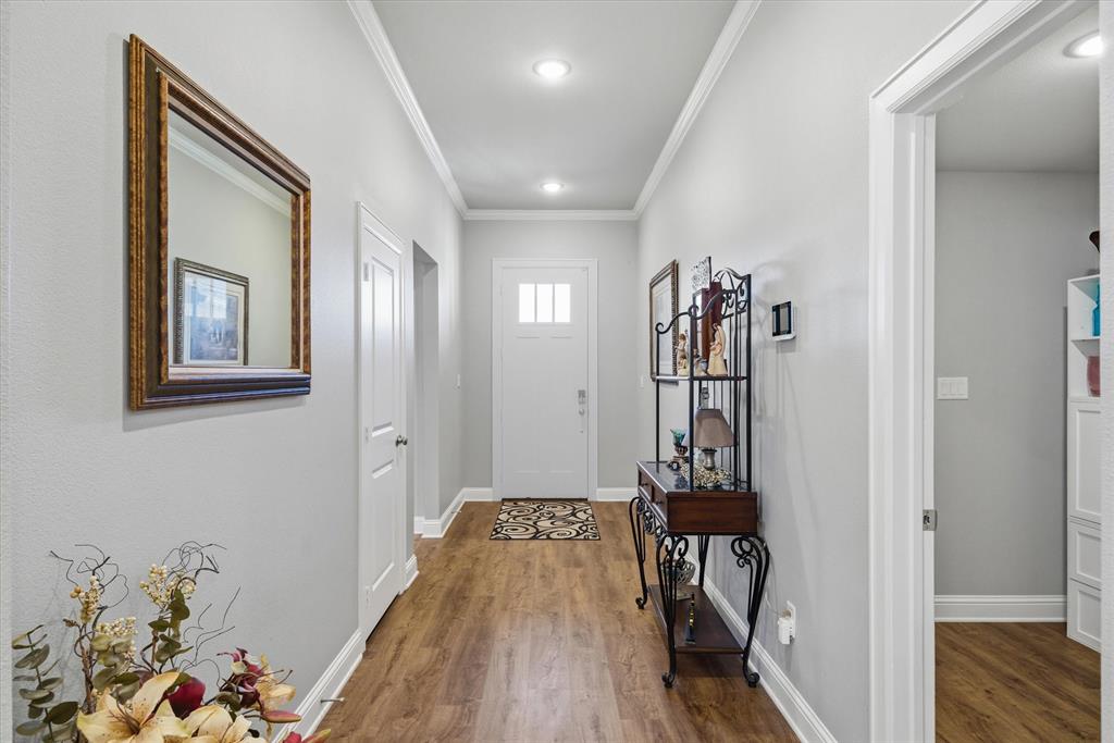 10059 Dayspring Drive Flint, TX 75762 - Photo 19 of 37 a view of a hallway with wooden floor and a livingroom