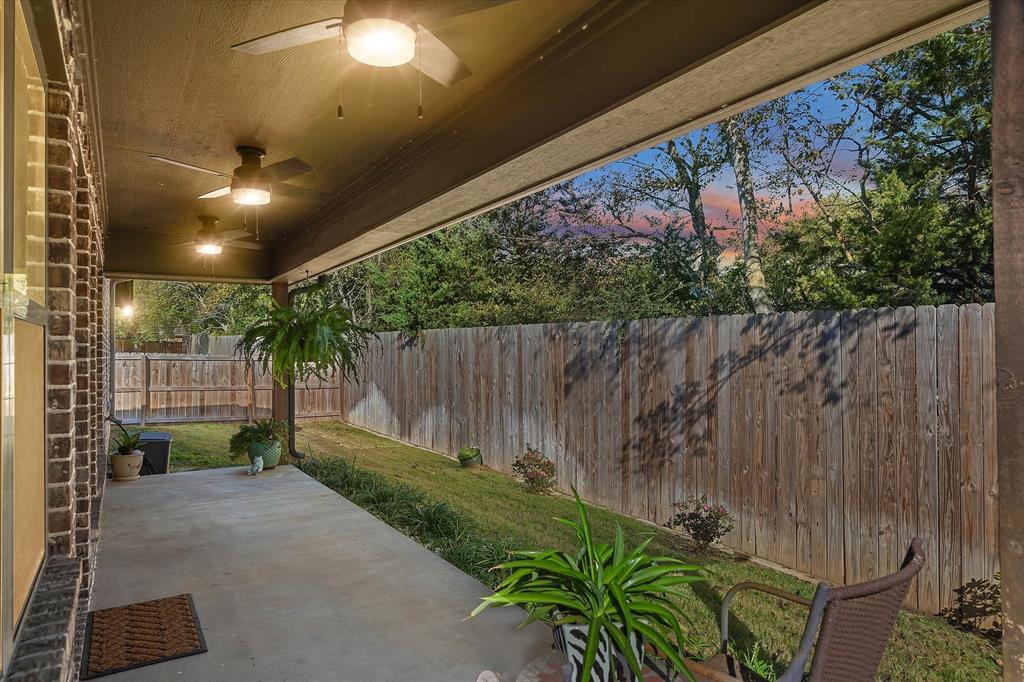 10059 Dayspring Drive Flint, TX 75762 - Photo 2 of 37 a backyard of a house with a garden and plants