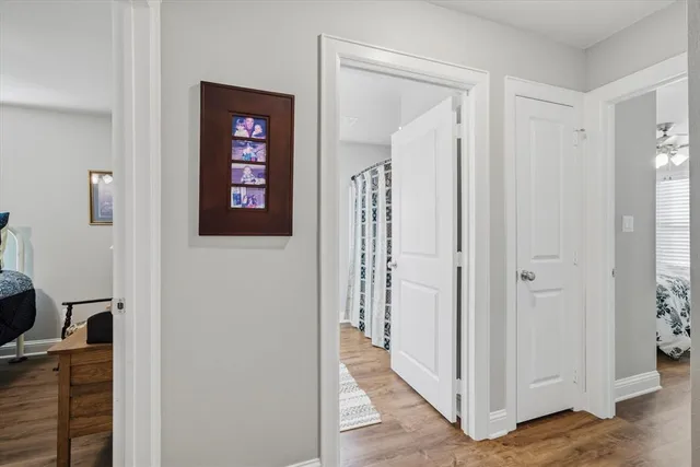 a view of a hallway with wooden floor and closet
