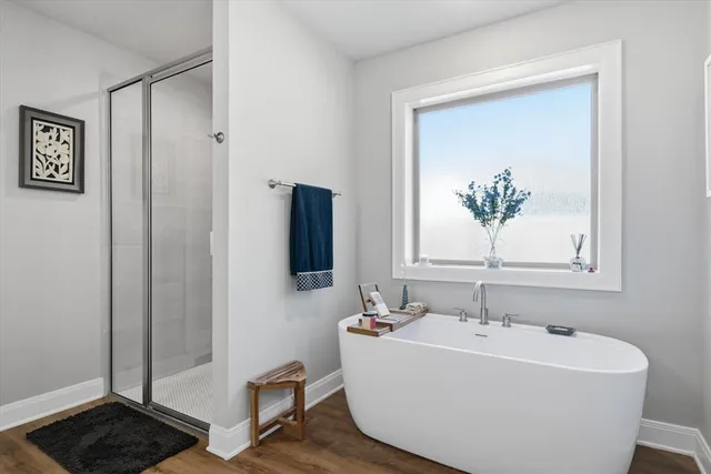 a bathroom with a bathtub and a window