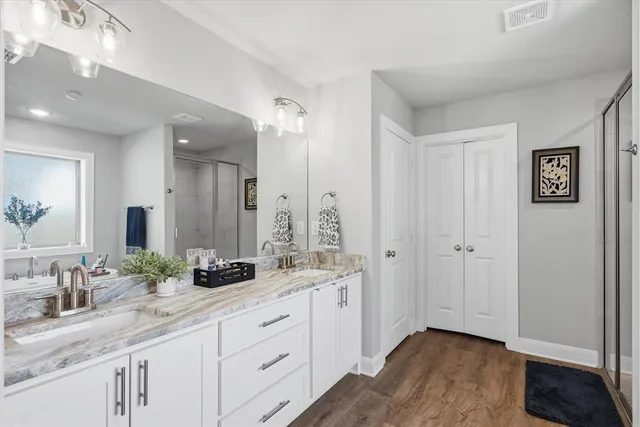 a bathroom with a granite countertop sink and a mirror