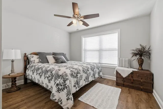 a spacious bedroom with a bed a couch and a window