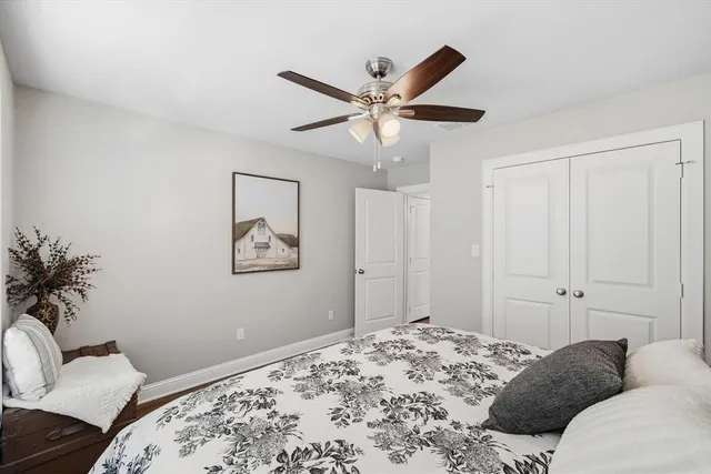 a bedroom with a large bed and a chandelier