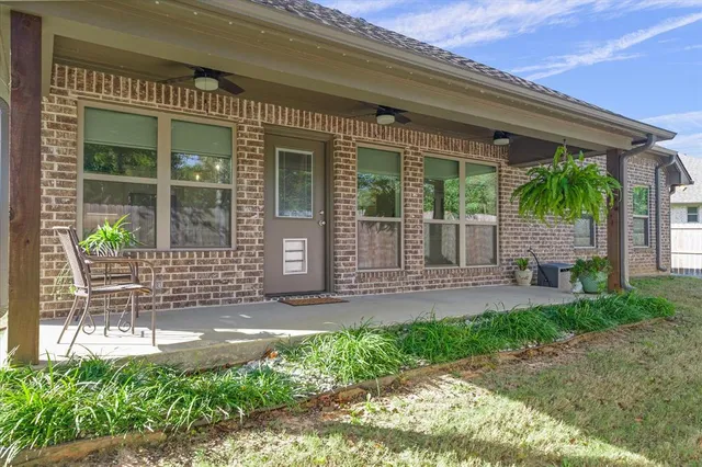 a front view of a house with a garden and plants