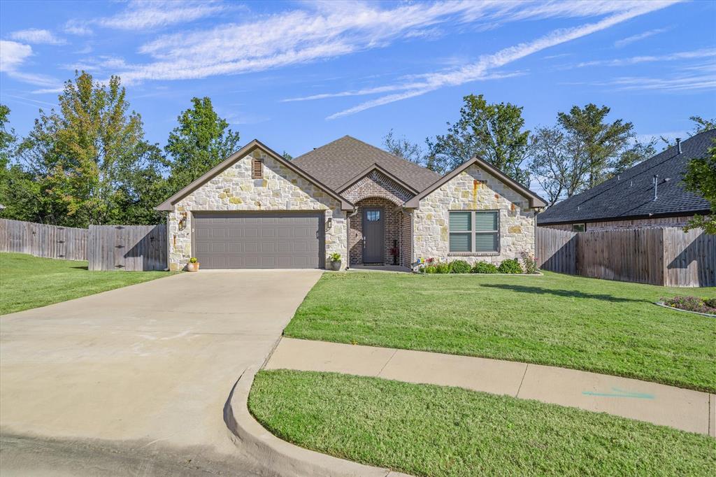 10059 Dayspring Drive Flint, TX 75762 - Photo 4 of 37 a front view of a house with a yard and garage