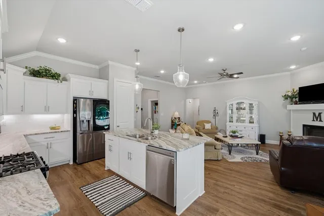 a kitchen with a sink stainless steel appliances and cabinets