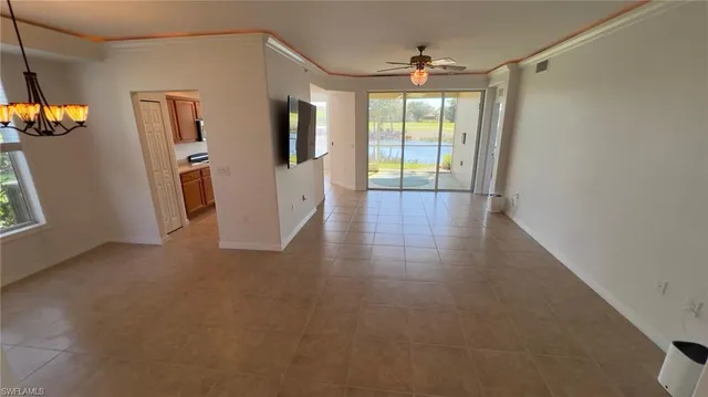 an empty room with wooden floor and mirror
