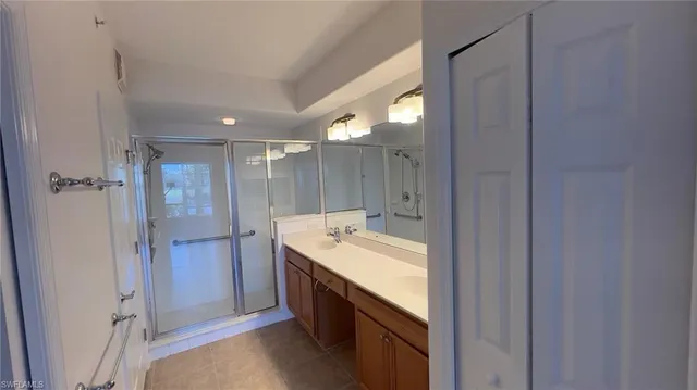 a view of a house with a yard and potted plants