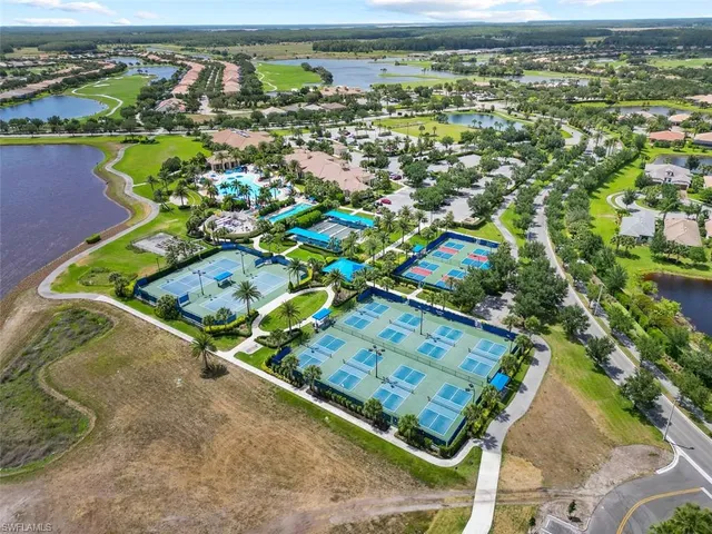 an aerial view of lake and residential houses with outdoor space