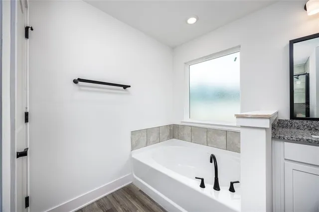 a bathroom with a tub and a sink