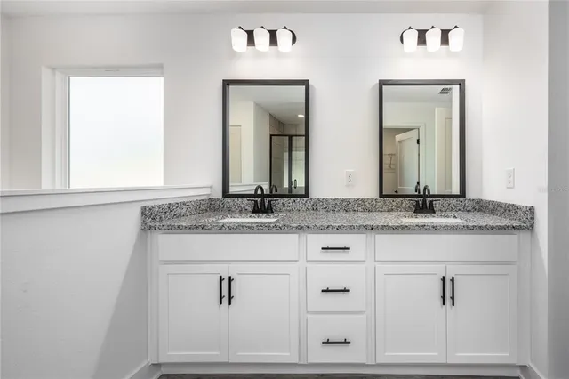 a bathroom with sink mirror and vanity