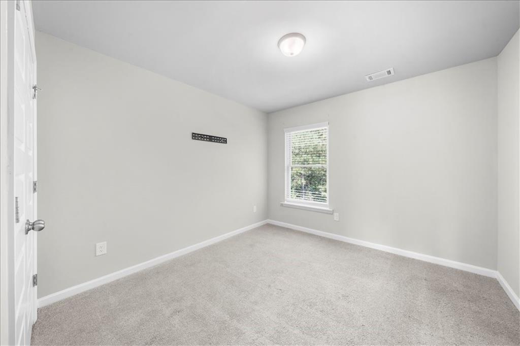 300 Harrison Street Calhoun, GA 30701 - Photo 9 of 17 an empty room with windows