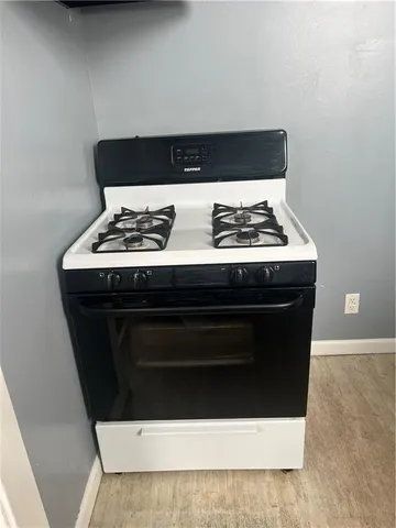 a stove top oven sitting inside of a kitchen