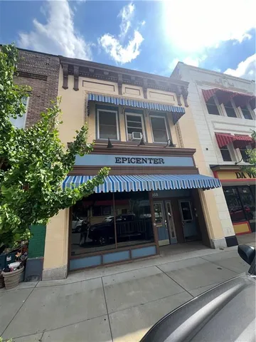 a front view of a building with garage
