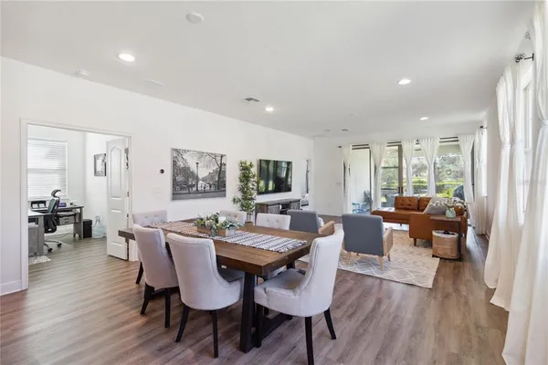 a view of a dining room and livingroom with furniture wooden floor