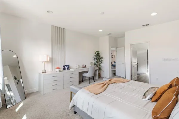 a bedroom with bed and large window