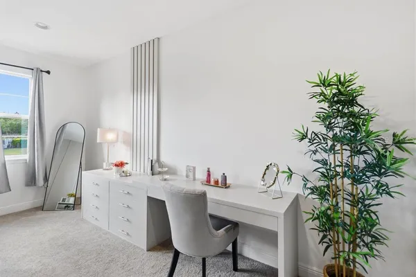 a bedroom with a bed and large windows