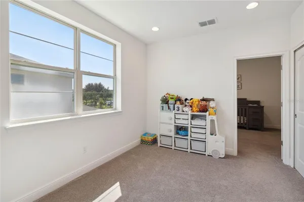 a room with a dresser and a window