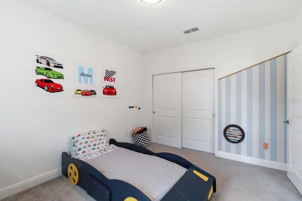 a bedroom with a bed and a desk