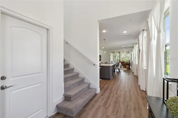 a large kitchen with stainless steel appliances a lot of counter space and a wooden floors
