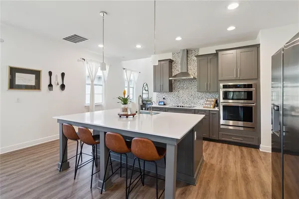 a kitchen with granite countertop white cabinets stainless steel appliances and sink