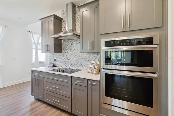 a kitchen with stainless steel appliances granite countertop a sink a stove and a refrigerator