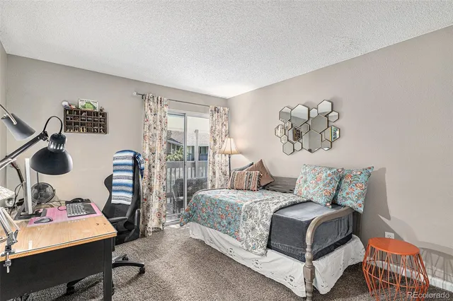 a bedroom with a bed and a table in it