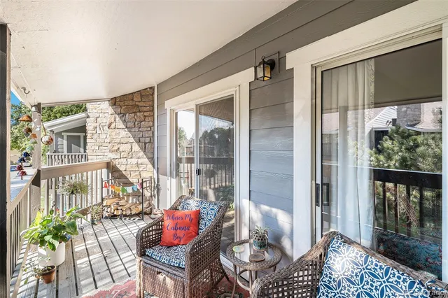 a balcony with furniture and a potted plant