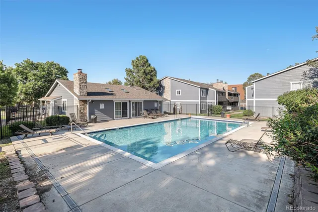 a view of a house with pool and a yard