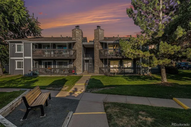 a aerial view of a house with a yard table and chairs