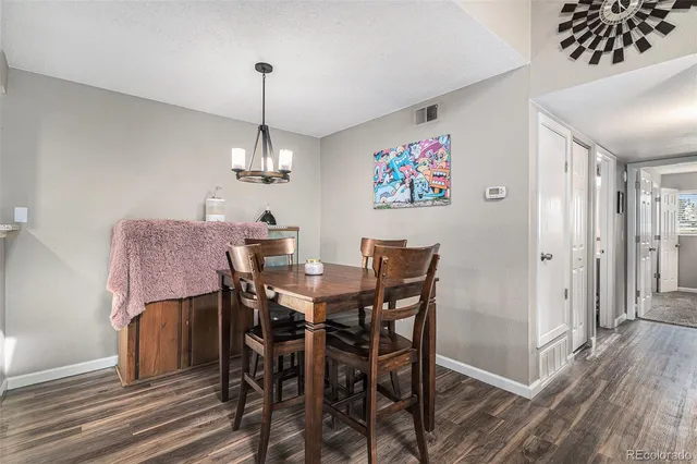 a view of a dining room with furniture wooden floor and a chandelier