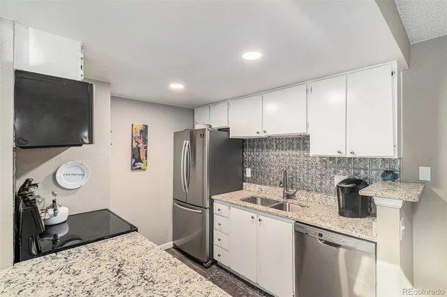 a kitchen with a refrigerator and a sink