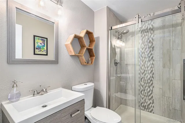 a bathroom with a sink toilet and shower