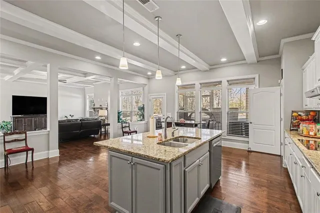 a view of living room with granite countertop furniture and a flat screen tv