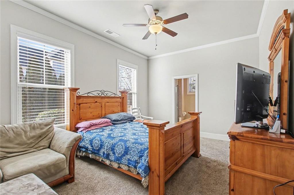 971 Traditions Way Jefferson, GA 30549 - Photo 16 of 53 a bedroom with a bed and a flat screen tv