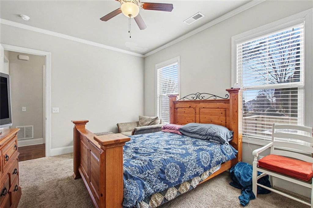 971 Traditions Way Jefferson, GA 30549 - Photo 17 of 53 a bedroom with a bed and a chandelier