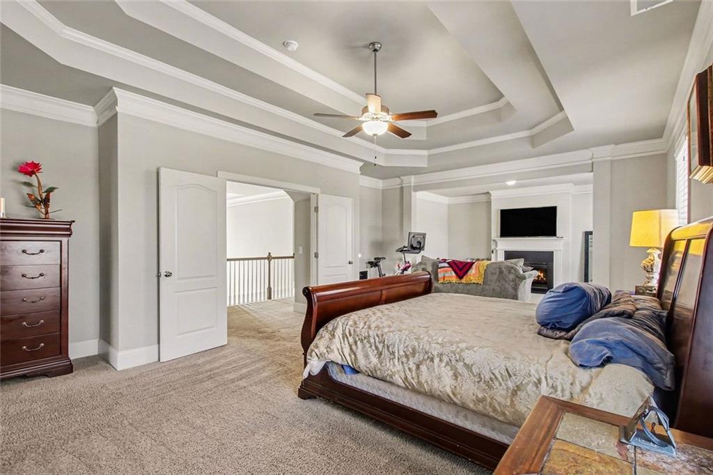 971 Traditions Way Jefferson, GA 30549 - Photo 22 of 53 a bedroom with double bed and a chandelier