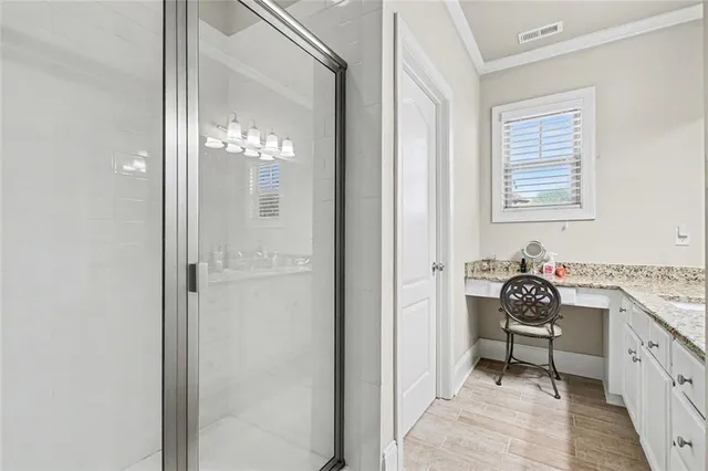 a en suite bathroom with a shower sink and mirror