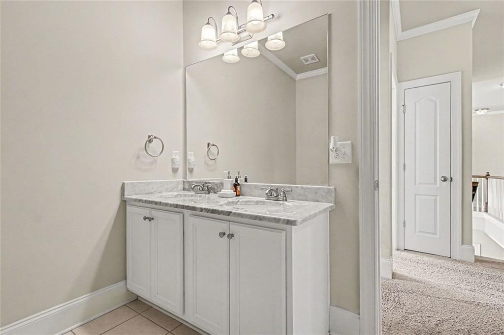 971 Traditions Way Jefferson, GA 30549 - Photo 35 of 53 a bathroom with a granite countertop sink a light fixture and a mirror