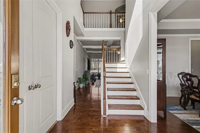 a view of entryway and hall with wooden floor