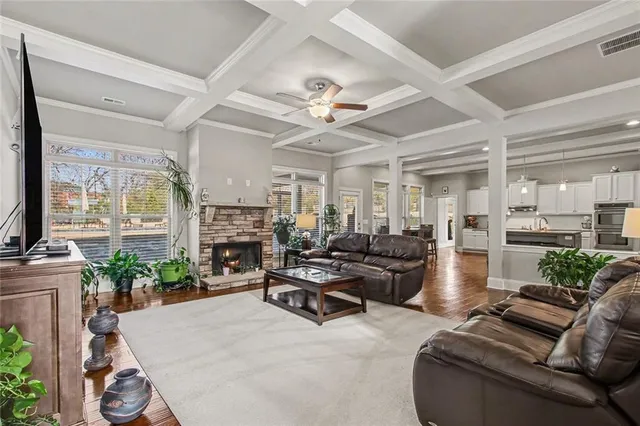 a living room with furniture fireplace and a large window