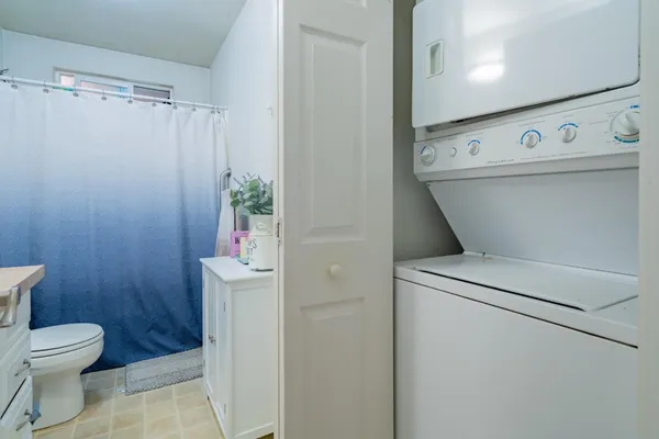 a bathroom with a sink a toilet and shower curtain