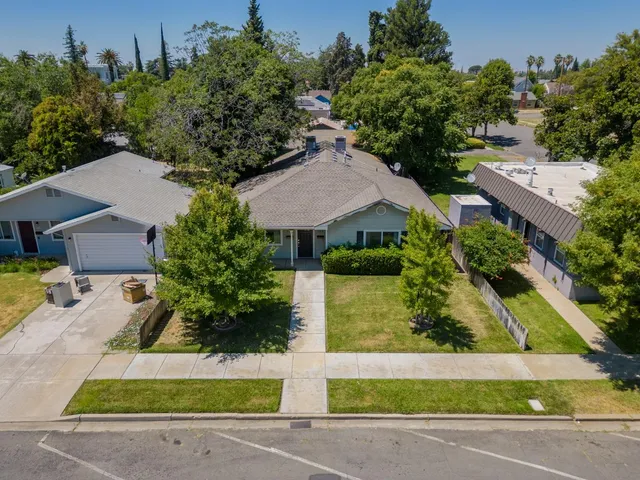 an aerial view of multiple houses with a yard