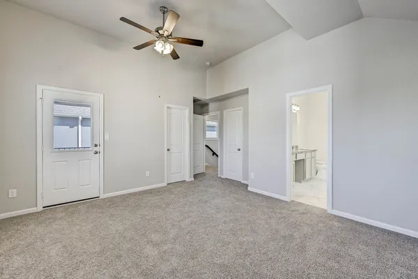 a view of an empty room and a ceiling fan window