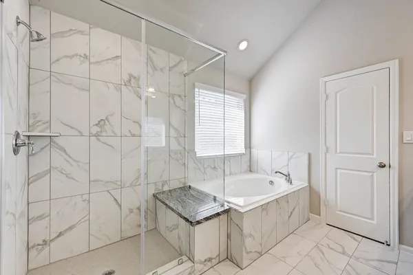 a bathroom with a bathtub and shower