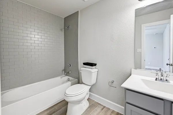 a bathroom with a toilet a sink and bathtub
