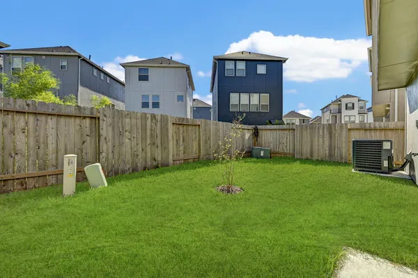 a view of a chair and table in back yard of the house
