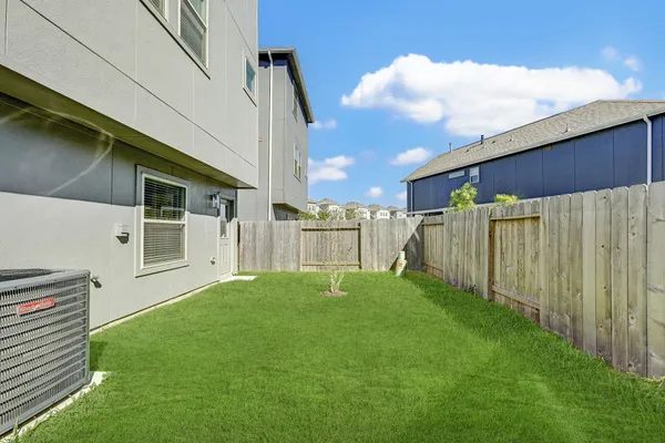 a backyard of a house with table and chairs