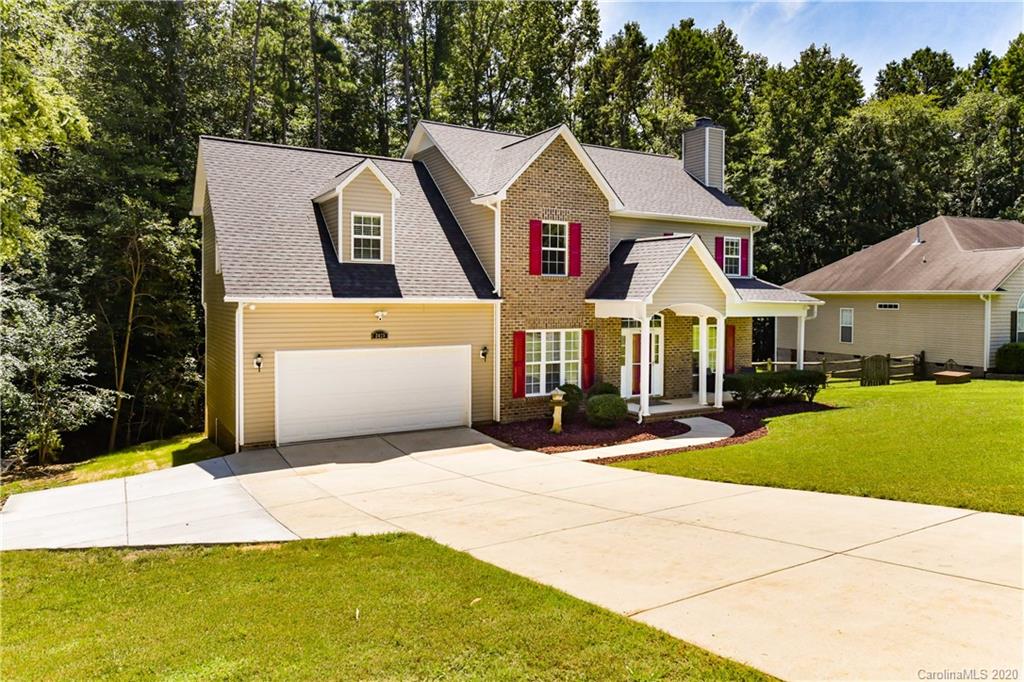 2425 Lakeview Circle Matthews, NC 28105 - Photo 2 of 33 a front view of a house with yard and garage