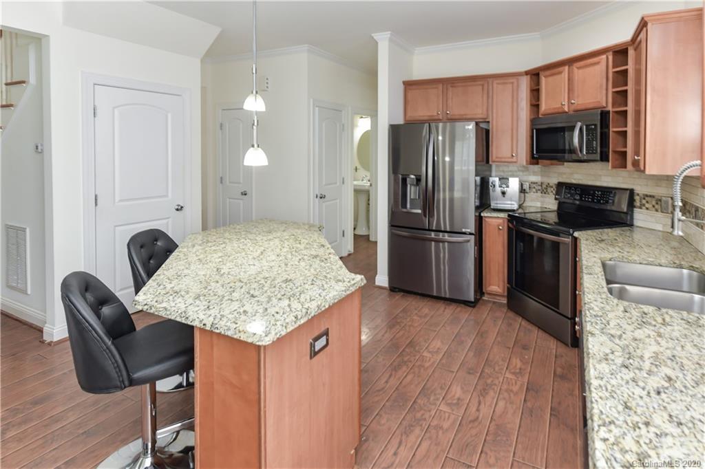 2425 Lakeview Circle Matthews, NC 28105 - Photo 11 of 33 a kitchen with stainless steel appliances granite countertop a stove refrigerator and microwave